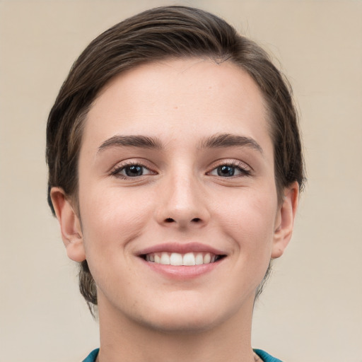 Joyful white young-adult female with short  brown hair and grey eyes