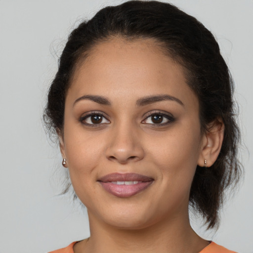 Joyful latino young-adult female with medium  brown hair and brown eyes