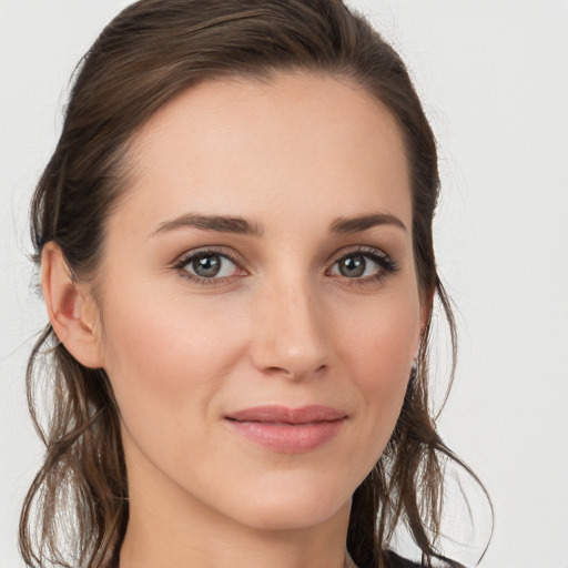 Joyful white young-adult female with long  brown hair and grey eyes