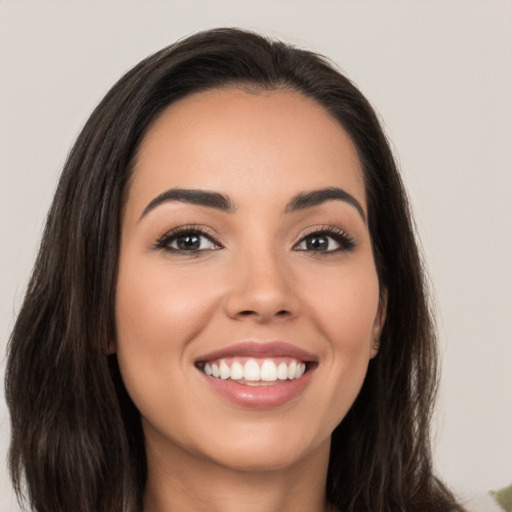 Joyful white young-adult female with long  brown hair and brown eyes