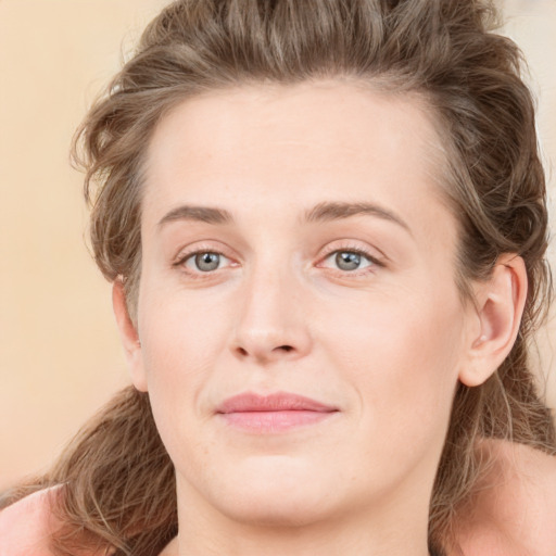 Joyful white young-adult female with medium  brown hair and green eyes