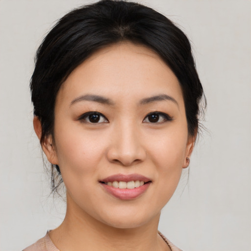 Joyful asian young-adult female with medium  brown hair and brown eyes