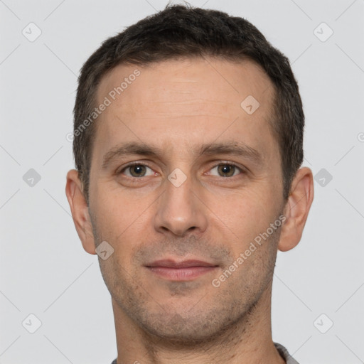 Joyful white adult male with short  brown hair and brown eyes