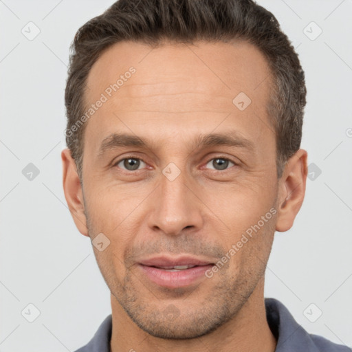 Joyful white adult male with short  brown hair and brown eyes