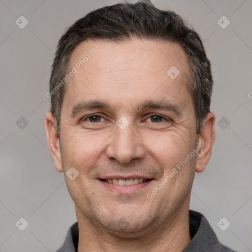 Joyful white adult male with short  brown hair and grey eyes