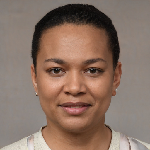 Joyful black young-adult female with short  black hair and brown eyes