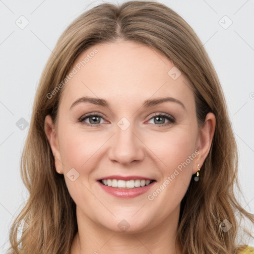 Joyful white young-adult female with long  brown hair and green eyes