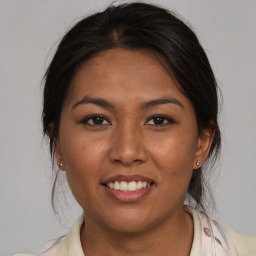 Joyful asian young-adult female with medium  brown hair and brown eyes