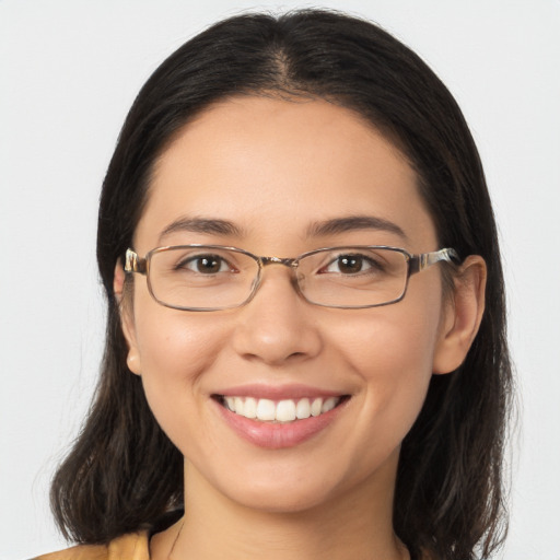 Joyful white young-adult female with long  brown hair and brown eyes