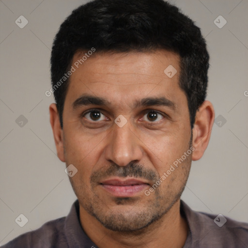 Joyful white adult male with short  black hair and brown eyes