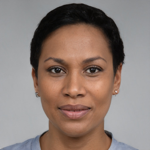 Joyful black young-adult female with short  black hair and brown eyes