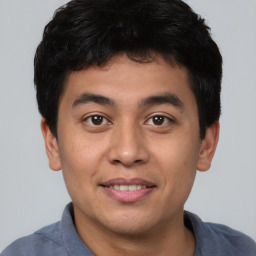 Joyful asian young-adult male with short  black hair and brown eyes