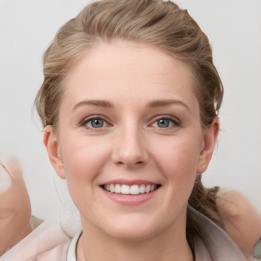 Joyful white young-adult female with medium  brown hair and blue eyes