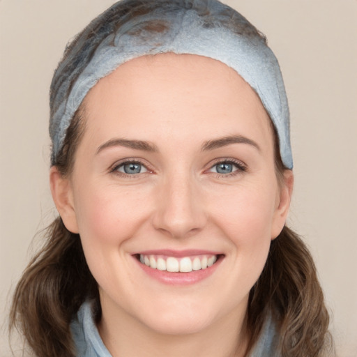 Joyful white young-adult female with medium  brown hair and blue eyes