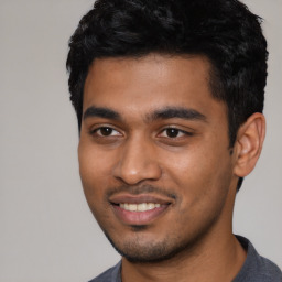 Joyful latino young-adult male with short  black hair and brown eyes