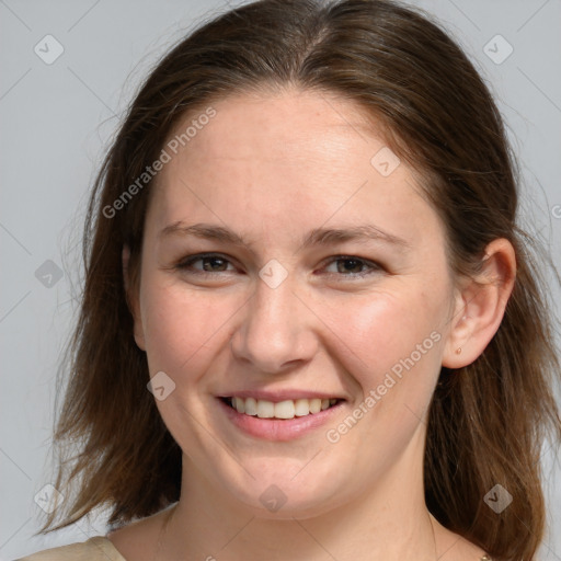 Joyful white adult female with medium  brown hair and grey eyes