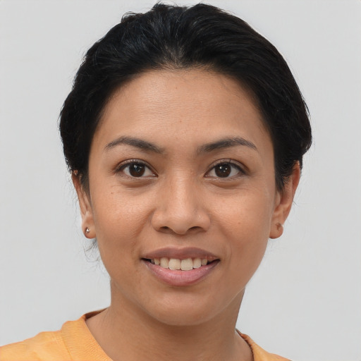 Joyful asian young-adult female with short  brown hair and brown eyes