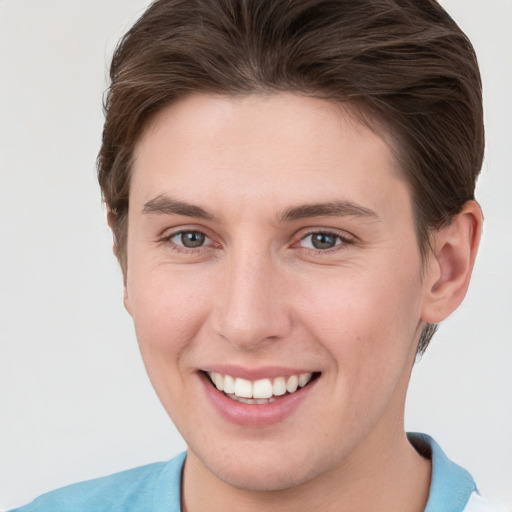 Joyful white young-adult female with short  brown hair and grey eyes