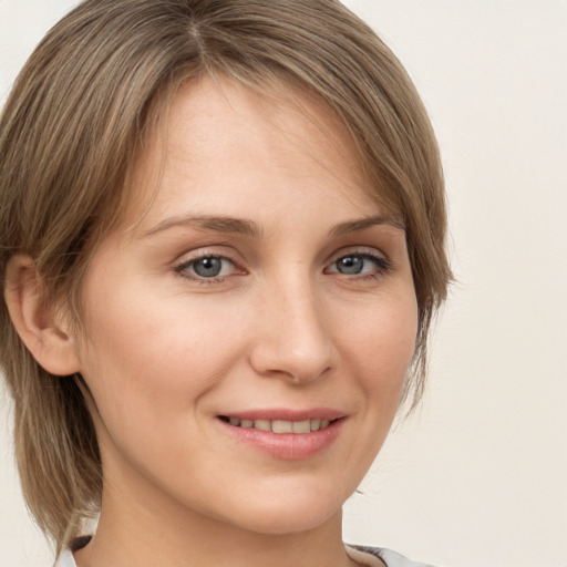 Joyful white young-adult female with medium  brown hair and green eyes