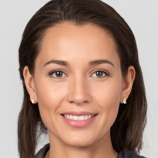 Joyful white young-adult female with medium  brown hair and brown eyes