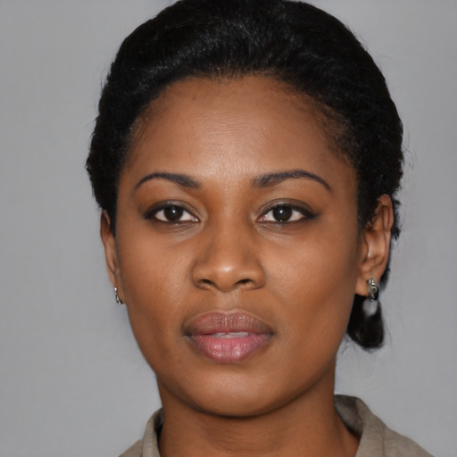 Joyful black young-adult female with short  black hair and brown eyes
