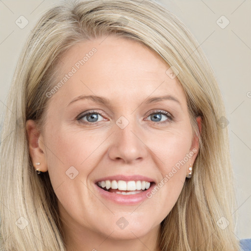 Joyful white young-adult female with long  brown hair and blue eyes