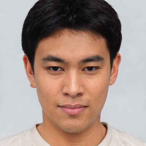 Joyful asian young-adult male with short  black hair and brown eyes