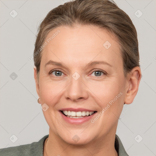 Joyful white adult female with short  brown hair and grey eyes