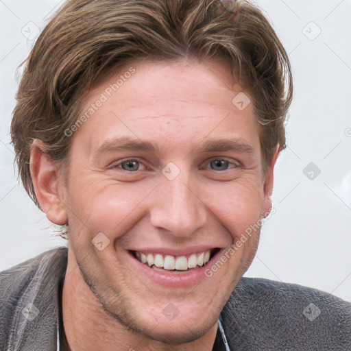 Joyful white young-adult male with short  brown hair and grey eyes