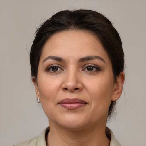 Joyful white adult female with medium  brown hair and brown eyes