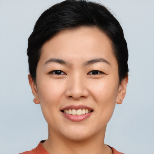 Joyful asian young-adult female with short  brown hair and brown eyes