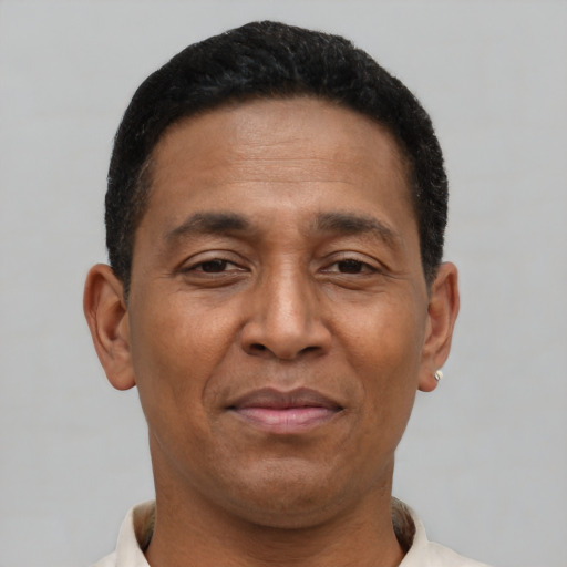 Joyful latino adult male with short  brown hair and brown eyes