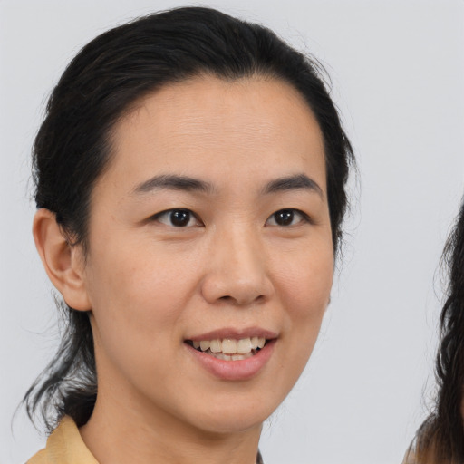 Joyful white young-adult female with medium  brown hair and brown eyes