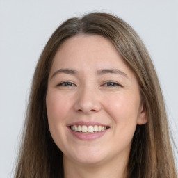 Joyful white young-adult female with long  brown hair and grey eyes