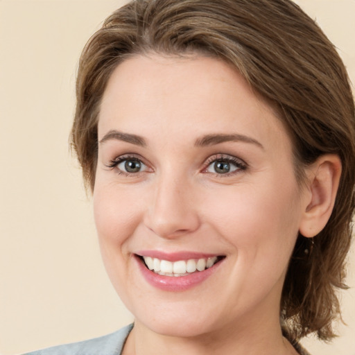 Joyful white young-adult female with medium  brown hair and green eyes