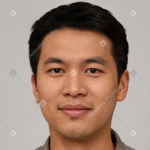 Joyful asian young-adult male with short  black hair and brown eyes