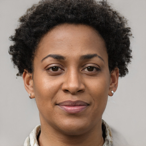 Joyful black young-adult female with short  brown hair and brown eyes