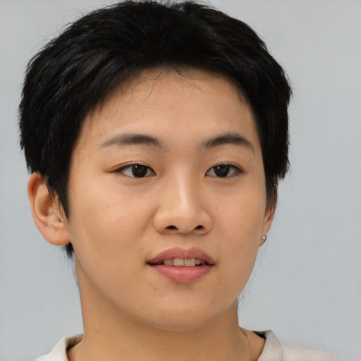 Joyful asian young-adult female with short  black hair and brown eyes