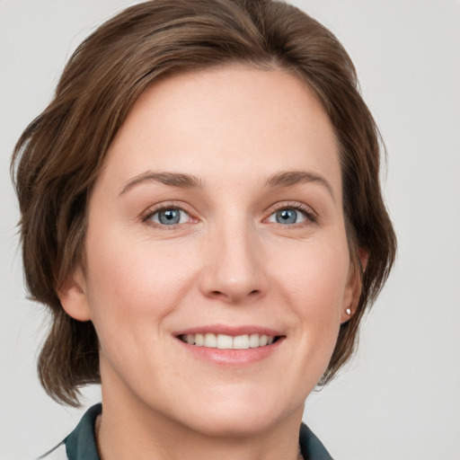 Joyful white young-adult female with medium  brown hair and blue eyes