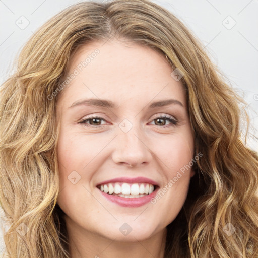 Joyful white young-adult female with long  brown hair and green eyes