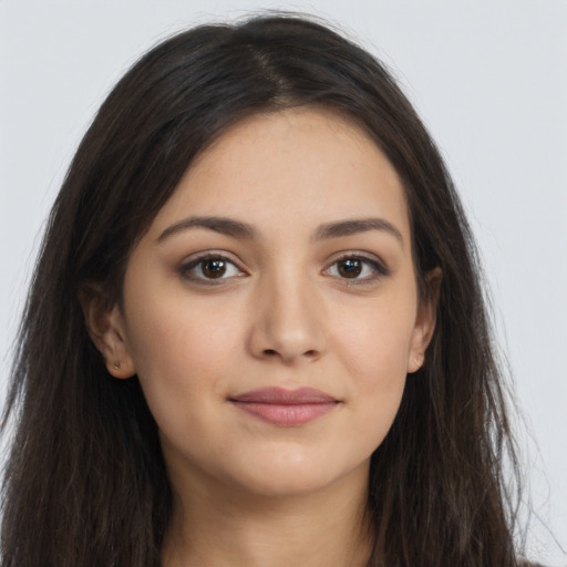 Joyful latino young-adult female with long  brown hair and brown eyes