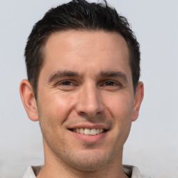 Joyful white young-adult male with short  brown hair and brown eyes