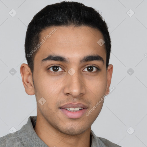 Joyful latino young-adult male with short  brown hair and brown eyes