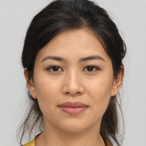 Joyful asian young-adult female with medium  brown hair and brown eyes