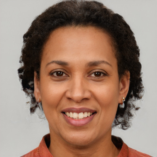 Joyful black adult female with short  brown hair and brown eyes