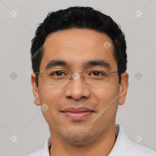 Joyful latino adult male with short  black hair and brown eyes