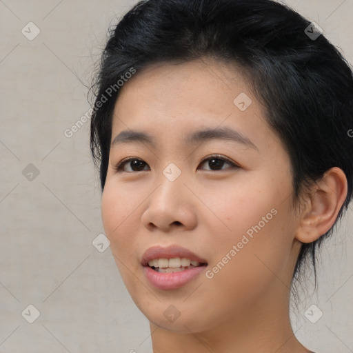 Joyful asian young-adult female with short  black hair and brown eyes