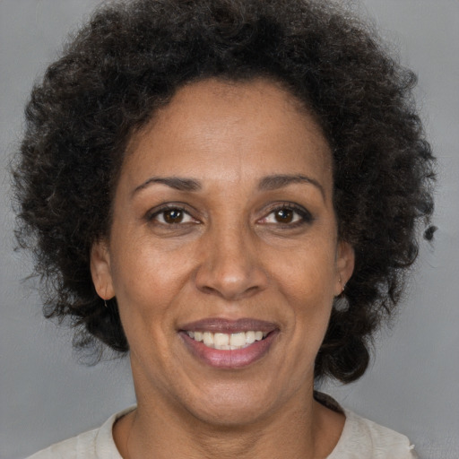 Joyful black adult female with short  brown hair and brown eyes