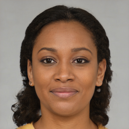 Joyful black young-adult female with medium  brown hair and brown eyes