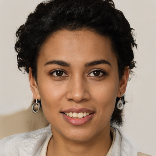 Joyful latino young-adult female with short  black hair and brown eyes